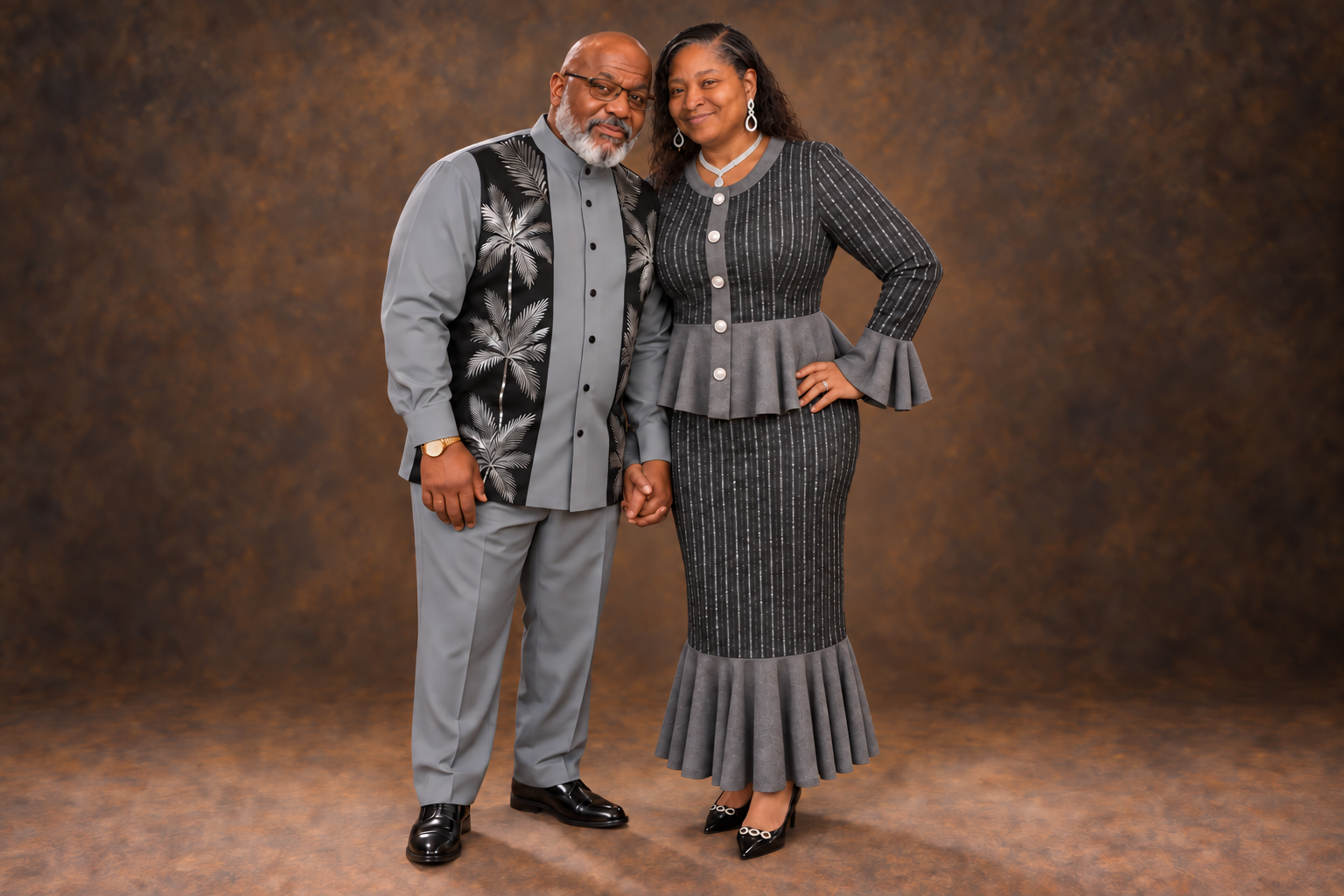 Bishop W. F. Houston Jr. and First Lady Donece D. Houston standing together in coordinated gray and black attire